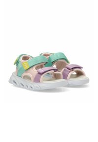 Chanclas deportivas coloridas con una parte superior de tela en rosa y lavanda, tiras turquesa, cierres de gancho y bucle, y una suela blanca flexible.
