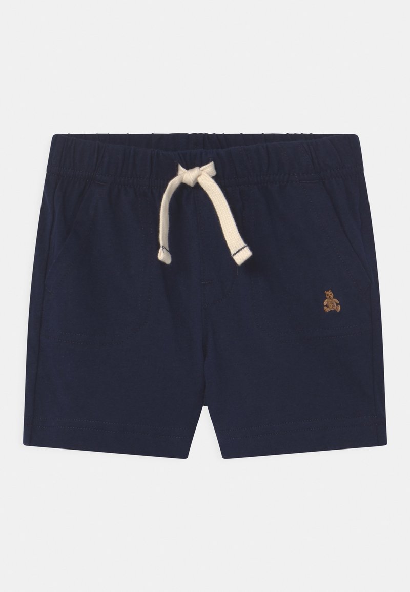 Shorts bleu marine pour tout-petit avec taille élastique, cordon de serrage crème, poches latérales et petit ours en peluche brodé sur la jambe droite.