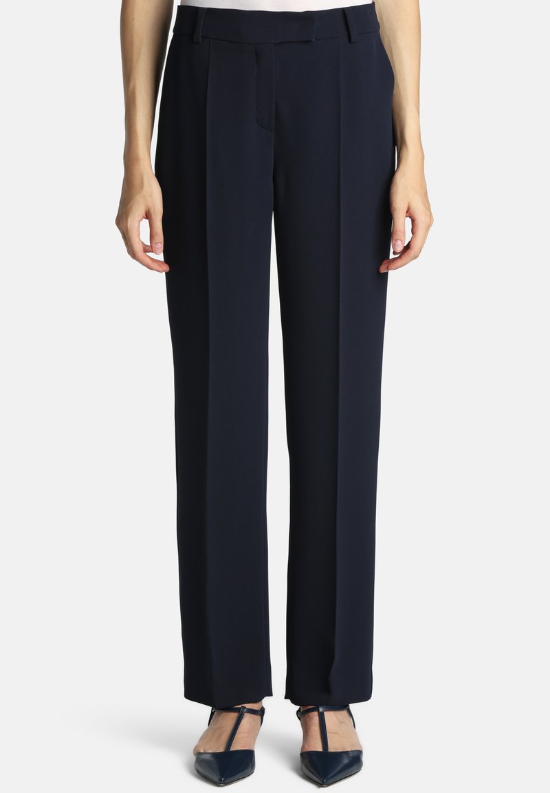 Navy blue tailored pants featuring a high waist, flat front, and wide leg design, made from a smooth fabric with subtle sheen.