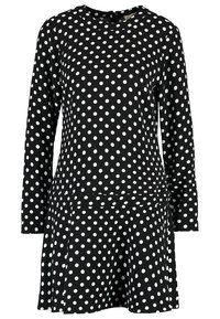 Robe noire à manches longues avec des pois blancs, col rond et jupe légèrement évasée.