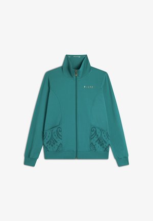 Giacca zippata teal con alto colletto, logo dorato e tasche decorate; realizzata in materiale leggero con una texture liscia.