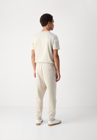 BOSS HADIKO - Spodnji deli trenirk - light beige