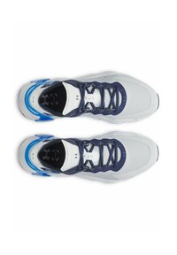 White and navy athletic shoes feature a mesh upper, blue accents, and a textured sole. Lace-up design with logo detail on the tongue.