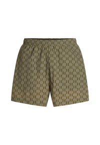 Shorts verde oliva con un motivo geometrico in verde scuro, vita elastica e una vestibilità rilassata. Materiale morbido con una consistenza liscia.