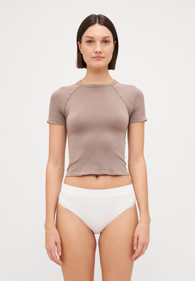 Brown short-sleeve top with a fitted design and ribbed texture, paired with white high-waisted briefs. Simple, clean lines and minimal detailing.