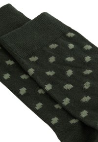 Temnozeleni pleteni nogavici s vzorcem majhnih svetlozelenih nepravilnih pik, raztresenih po tkanini.