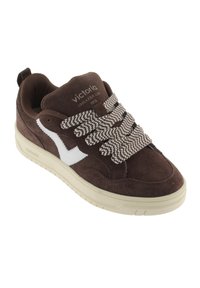 Sneaker in suede marrone con logo bianco e lacci a motivo marrone e bianco. Presenta una suola spessa color crema e supporto per la caviglia imbottito.
