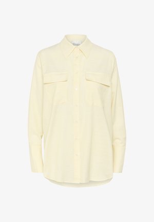 Langærmet skjorte i lys gul med et diskret ternet mønster, to forlommer og klassisk krave.