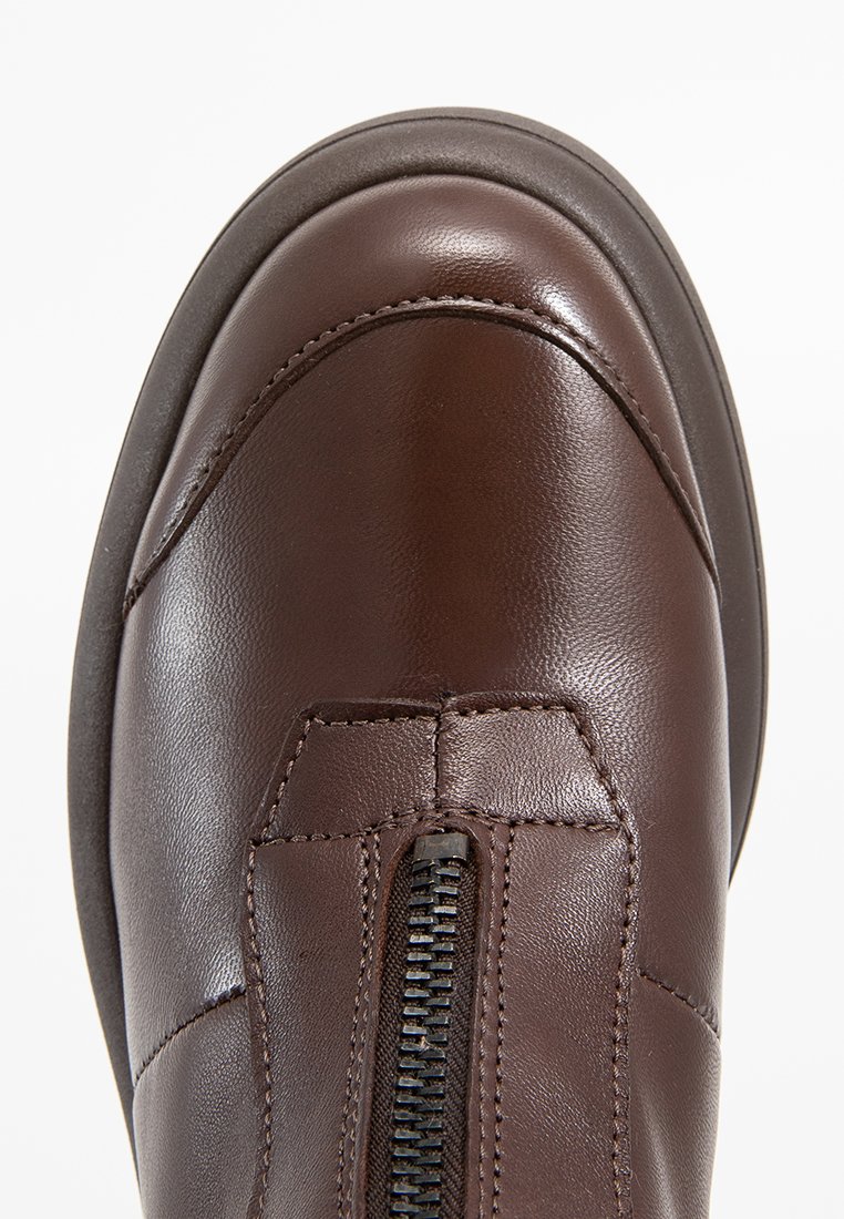 Braune Lederschuhe mit abgerundeter Zehe und zentralem schwarzen Reißverschluss, detaillierte Naht entlang des Obermaterials und schwarze Gummisohle.