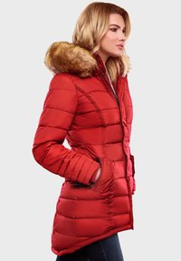Red padded coat with a faux fur hood, featuring horizontal quilting, a zipper closure, and side pockets. Smooth fabric texture.
