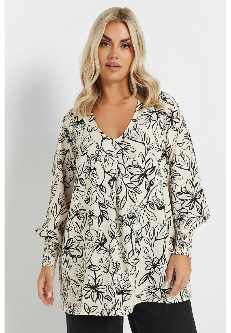 Blommig blus i kräm med svart botaniskt tryck, V-urringning, långa ärmar med samlade manschetter och en avslappnad passform.