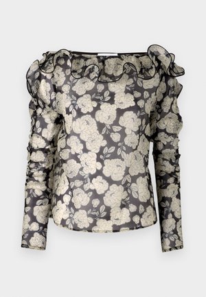 Kirkas musta paita, jossa on valkoinen kukkakuosi, röyhelökaulus, pitkät hihat, joissa on rypytettyjä yksityiskohtia, ja kapea malli.