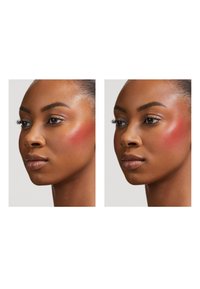 Two side-by-side portraits of a model with dark skin. Both display subtle blush, highlighting facial contours and a smooth texture.