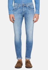 Slim fit niebieskie dżinsy w jasnym odcieniu z lekkim wyblaknięciem i przetarciami. Miękki denimo z klasycznym pięciopocketowym wzorem.