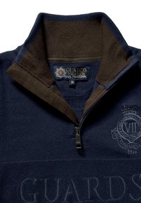 Navy and brown quarter-zip sweater featuring ribbed collar, embroidered logo and text, and textured fabric with a subtle pattern.