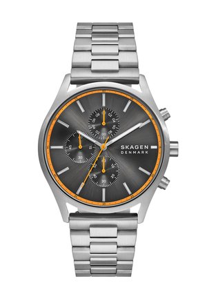 Ruostumattomasta teräksestä valmistettu kello, jossa on tummanharmaa pyöreä kellotaulu, kolme alikelloa, hopeiset viisarit ja oranssit yksityiskohdat. Varustettu linkkirannekkeella.