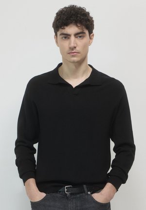 Black knit pullover with a collar, featuring long sleeves and ribbed cuffs. The fabric has a smooth texture and a classic fit.