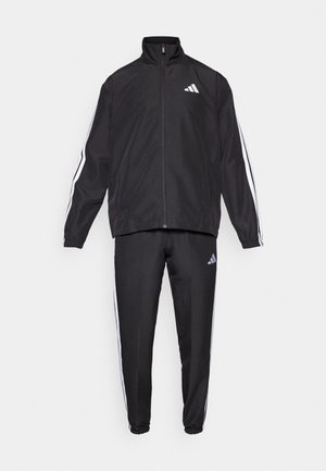 Black tracksuit with zip-up jacket and tapered pants. Features white stripes along sleeves and sides, made from a smooth, lightweight material.