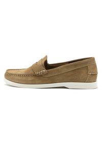 Mocassini in suede marrone con suola in gomma bianca, caratterizzati da un vamp cucito e dettagli laterali, e un accento con il marchio sul tallone.