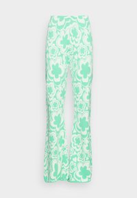 Calças largas em verde menta com um padrão floral em branco, feitas de um tecido suave com textura visível e um corte descontraído.