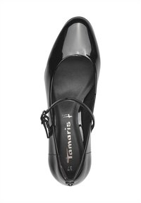 Black patent leather shoe with a rounded toe, ankle strap, and cushioned insole. Features branded insole with logo and size.