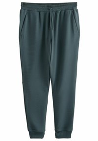 Donkergroene sportbroek van een gestructureerde stof, met een trekkoord in de taille en zijzakken. Gekraagde mouwen en een gladde oppervlakteafwerking.