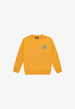 Żółta bluza crewneck z długim rękawem, z okrągłą naszywką logo na klatce piersiowej oraz ribbowymi mankietami i dołem. Wykonana z miękkiego materiału bawełnianego.