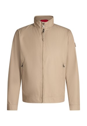 Veste beige à fermeture éclair avec col montant, boutons-pression et deux poches latérales zippées sur fond blanc.