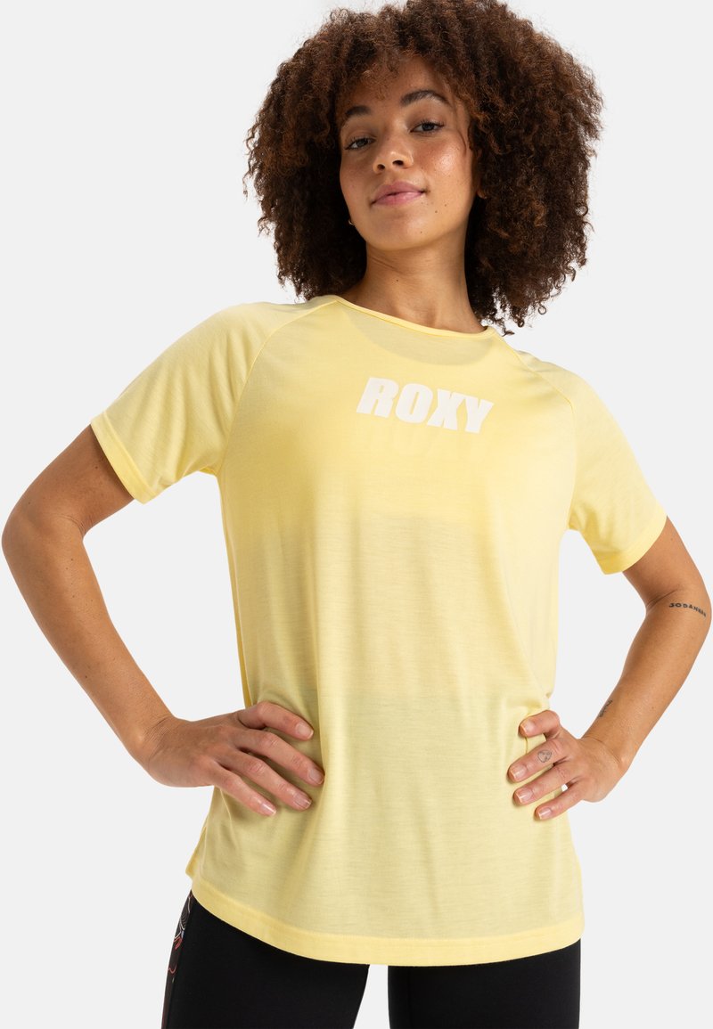 Gelbes T-Shirt mit kurzen Ärmeln, einem weichen Material und einem weißen "ROXY"-Logo auf der Vorderseite. Es hat eine entspannte Passform und einen runden Halsausschnitt.