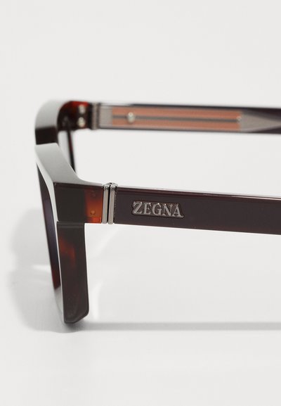 Zegna sunglasses with a rectangular brown tortoiseshell frame, featuring a metallic hinge and logo detail on the arm.