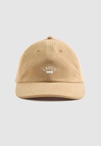 Tan corduroy cap with a curved brim and embroidered “LEVI'S” logo on the front. Features six ventilation holes, seamless design.