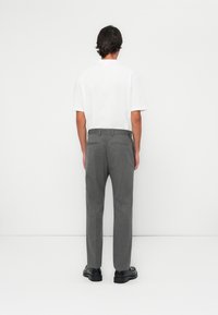 Gray trousers with a subtle pattern, featuring a straight leg design and two back pockets, paired with a plain white short-sleeve shirt.