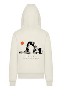 Cream hoodie featuring a black graphic of an arch structure and a sun, with the text "ESCAPE AND DISCOVER THE WORLD" below.