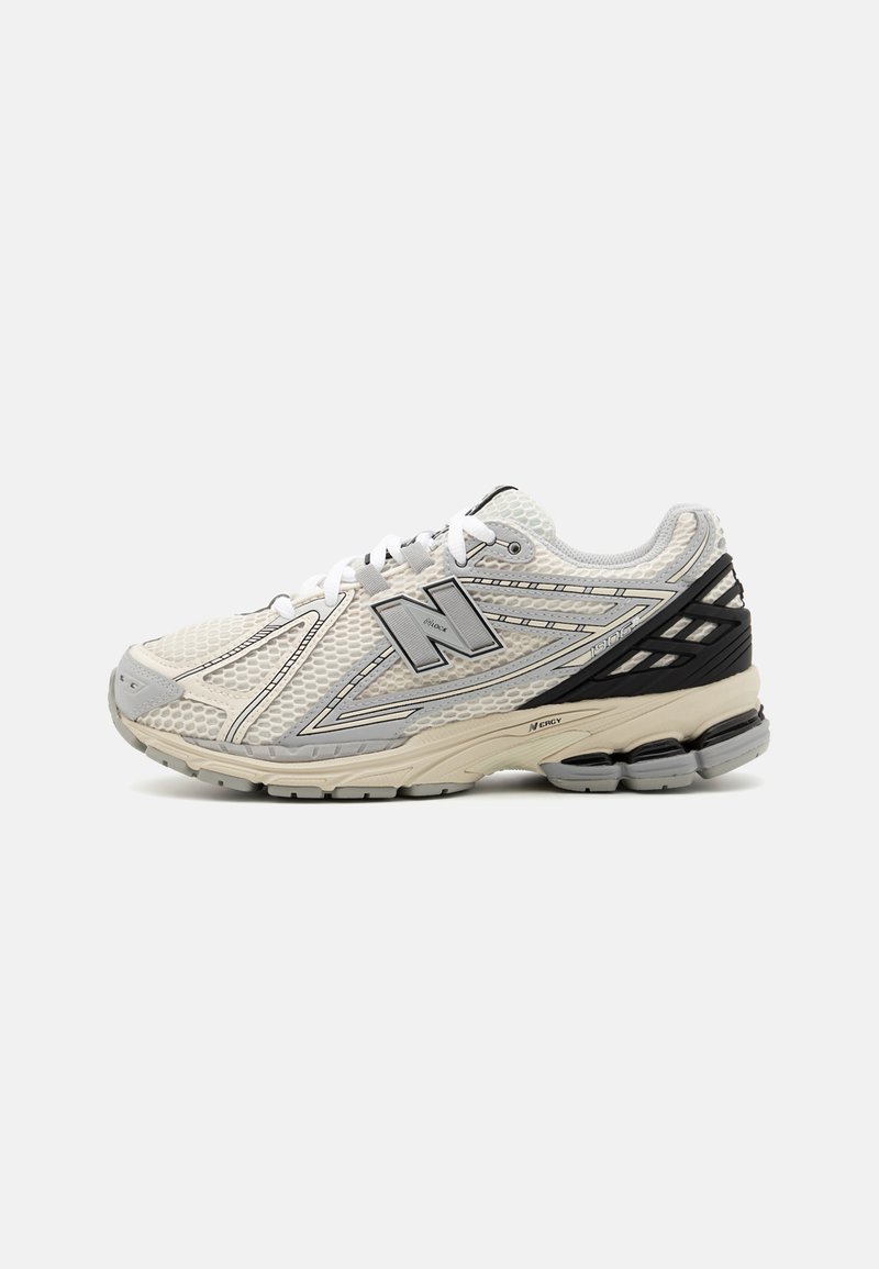 Men's running shoe in light gray and black, featuring mesh upper, reflective accents, and cushioned sole with textured detail.