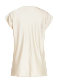 Top a maniche corte, color avorio, realizzato in un tessuto liscio e leggero con una vestibilità rilassata e scollo rotondo.
