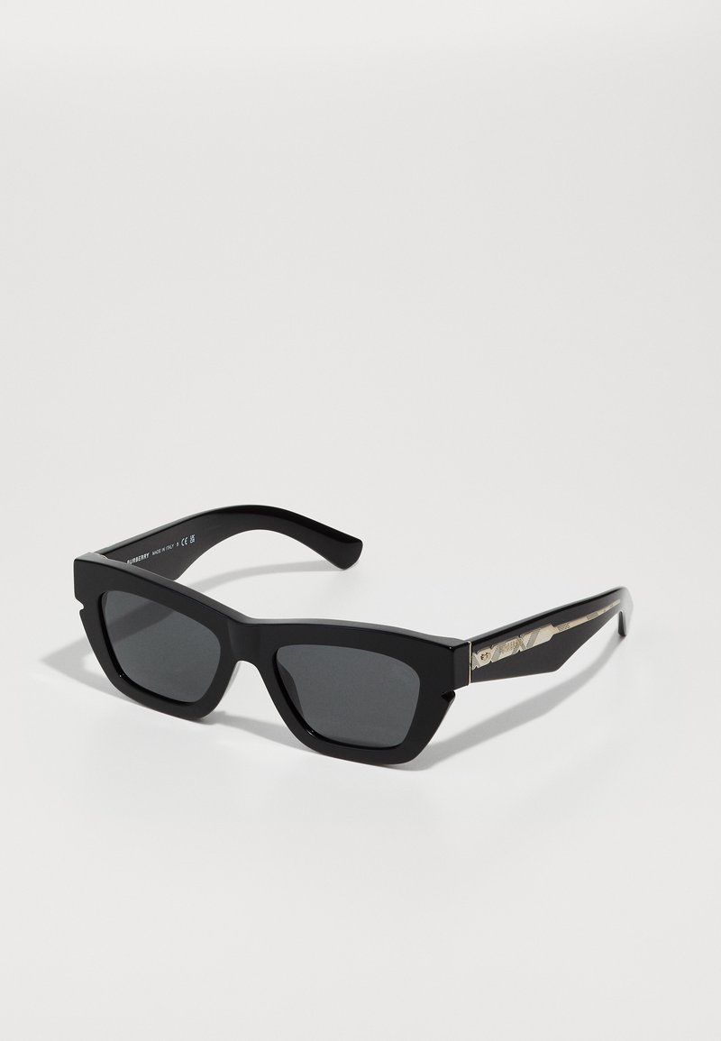 Black sunglasses with a thick, rectangular frame. Lenses are dark. Temples feature metallic accents with a snakeskin pattern.