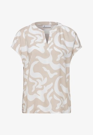Blouse beige à manches courtes avec motif tourbillon abstrait blanc et encolure ronde avec ouverture en V à l'avant.