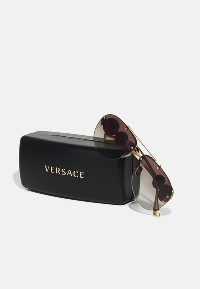 Versace sunglasses with gradient lenses in brown and gray, gold-tone hardware, and black protective case featuring embossed logo.