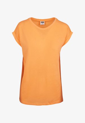 Camiseta de manga corta naranja, hecha de algodón suave, con cuello redondo y un corte holgado con mangas enrolladas. Textura suave, sin patrones.