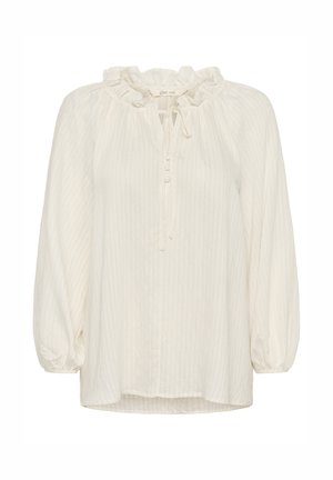 Hvit, lett bluse med volangkant ved halsen, lange ermer og knappestolpe. Har en subtil stripete tekstur gjennom hele stoffet.