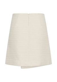 Mini-jupe texturée couleur crème avec un ourlet asymétrique et une fermeture éclair au dos.