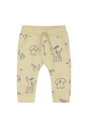 Beige Kleinkinderhose mit elastischen Bündchen und Taillenbund, Fronttaschen, Kordelzug und blauen sowie schwarzen Skizzen von Hunden und Kaninchen.