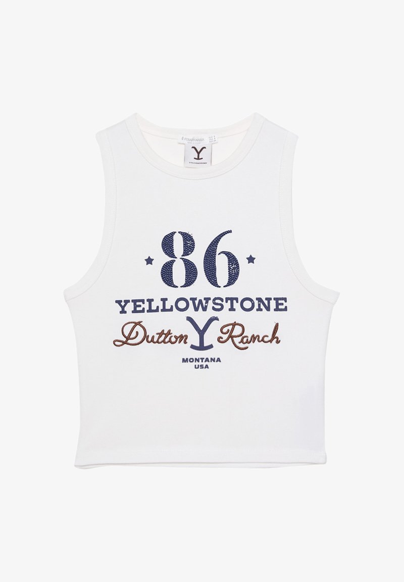 Wit mouwloos crop top met marineblauwe en bruine graphics waarop staat "86 YELLOWSTONE Dutton Ranch MONTANA USA" met steraccenten.