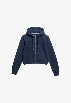Marineblauwe cropped hoodie van zacht stof, met een ritssluiting aan de voorkant, twee voorzakken en reliëftekst "Superdry University".