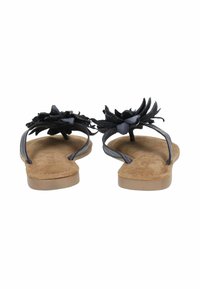 Infradito neri con decorazioni a fiore sulle cinghie, cuore in suede e suola in gomma marrone chiaro. Presentano un design minimalista e cinghie flessibili.
