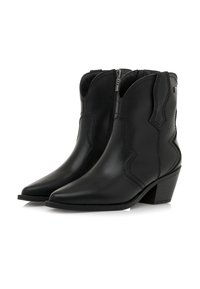 Par de botas de tobillo negras de tacón medio con puntas afiladas, cremalleras laterales y costuras decorativas en una superficie de cuero liso.