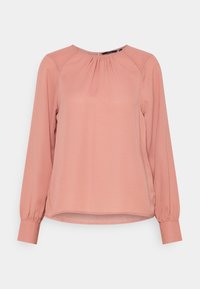 Blusa rosa chiaro con maniche lunghe e scollatura arricciata, con orlo arrotondato e chiusura con bottoni sulla parte posteriore. Tessuto dalla texture liscia.