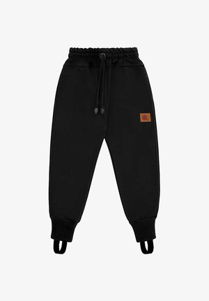 Czarne spodnie z elastyczną talią i regulowanym ściągaczem, ściągacze prążkowane z paskami na stopy oraz małą brązową naszywką z logo na prawej udzie.