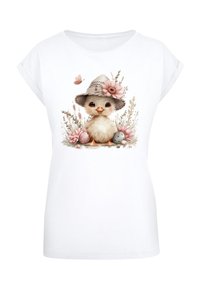 White t-shirt featuring a cute chick illustration with a hat, flowers, and pastel-colored eggs, displayed on a plain background.