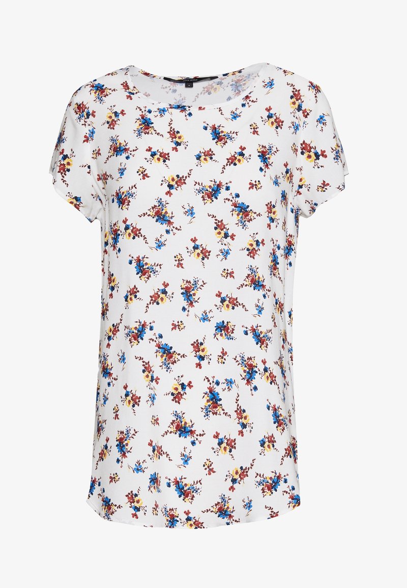 Blouse blanche à manches courtes avec un col rond, présentant un motif floral dispersé en rouge, bleu et jaune.